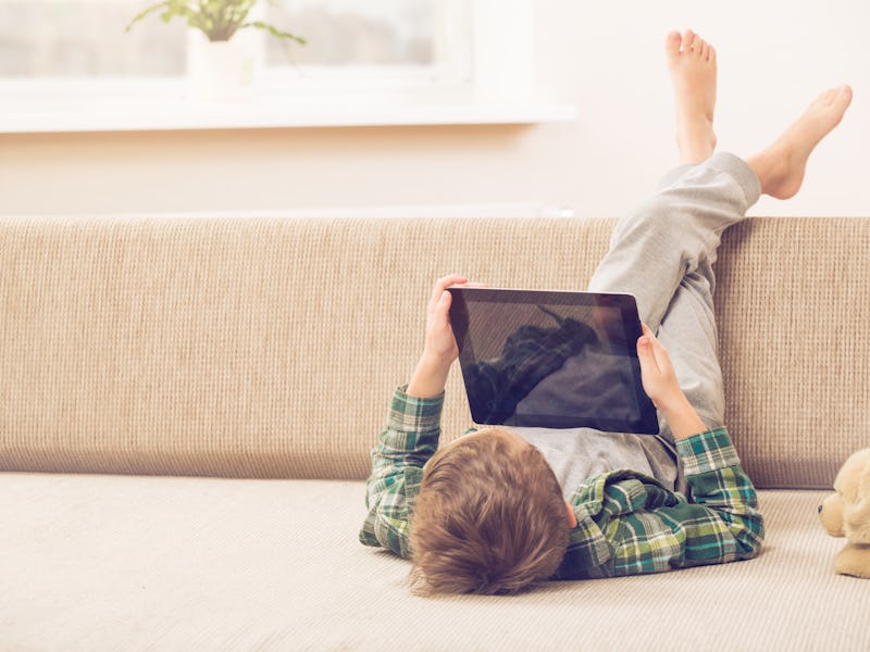 boy playing with digital tablet