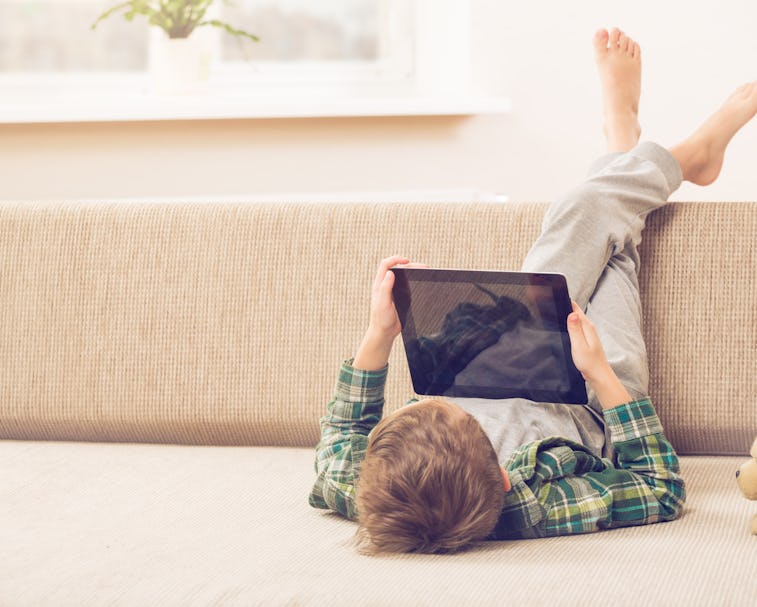 boy playing with digital tablet