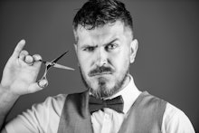Businessman strict face hold scissors. Barber with beard and mustache hold steel scissors. Grooming ...