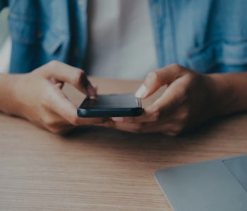 Young man using mobile phone. Using online connect technology for business, education and communicat...