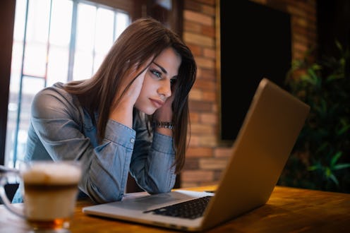 Frustrated worried young woman looks at laptop upset by bad news, teenager feels shocked afraid read...