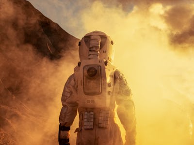 Courageous Astronaut in the Space Suit Explores Red Planet Mars Covered in Mist