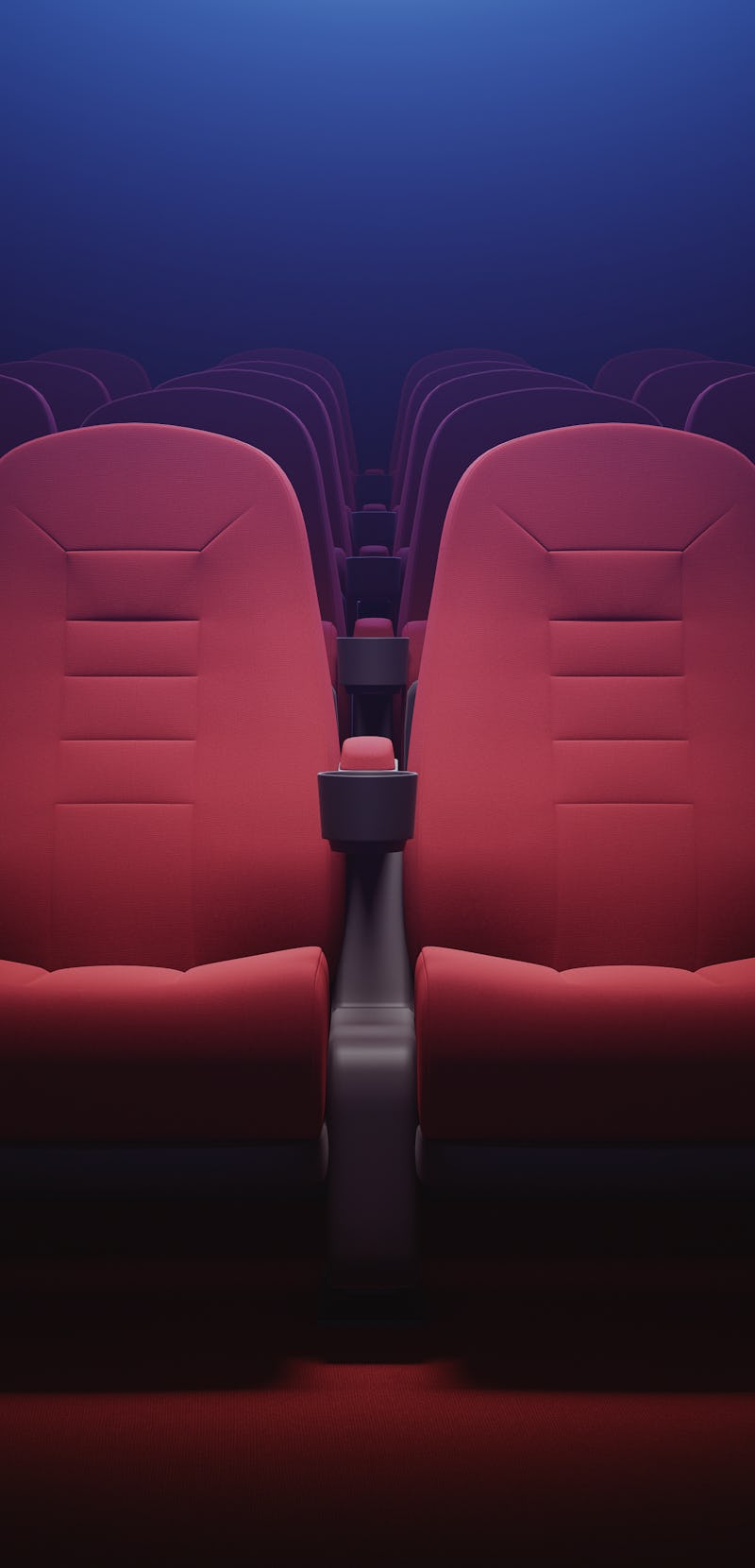 Interior of empty cinema with rows of red seats with cup holders and popcorn. Concept of entertainme...