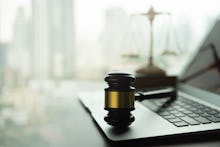 law legal technology concept. judge gavel and computer on desk of lawyer with legal icon.