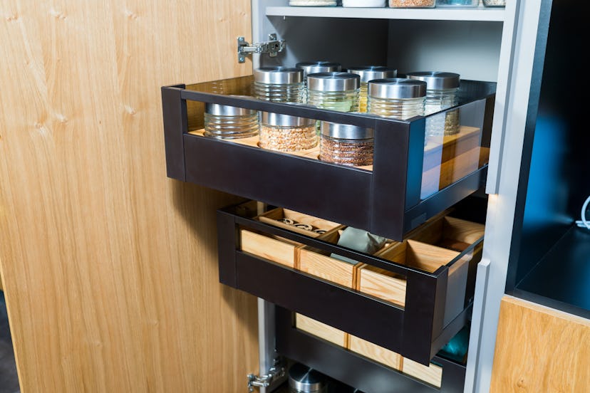 Sliding drawers help with deep kitchen cupboard for food storage.