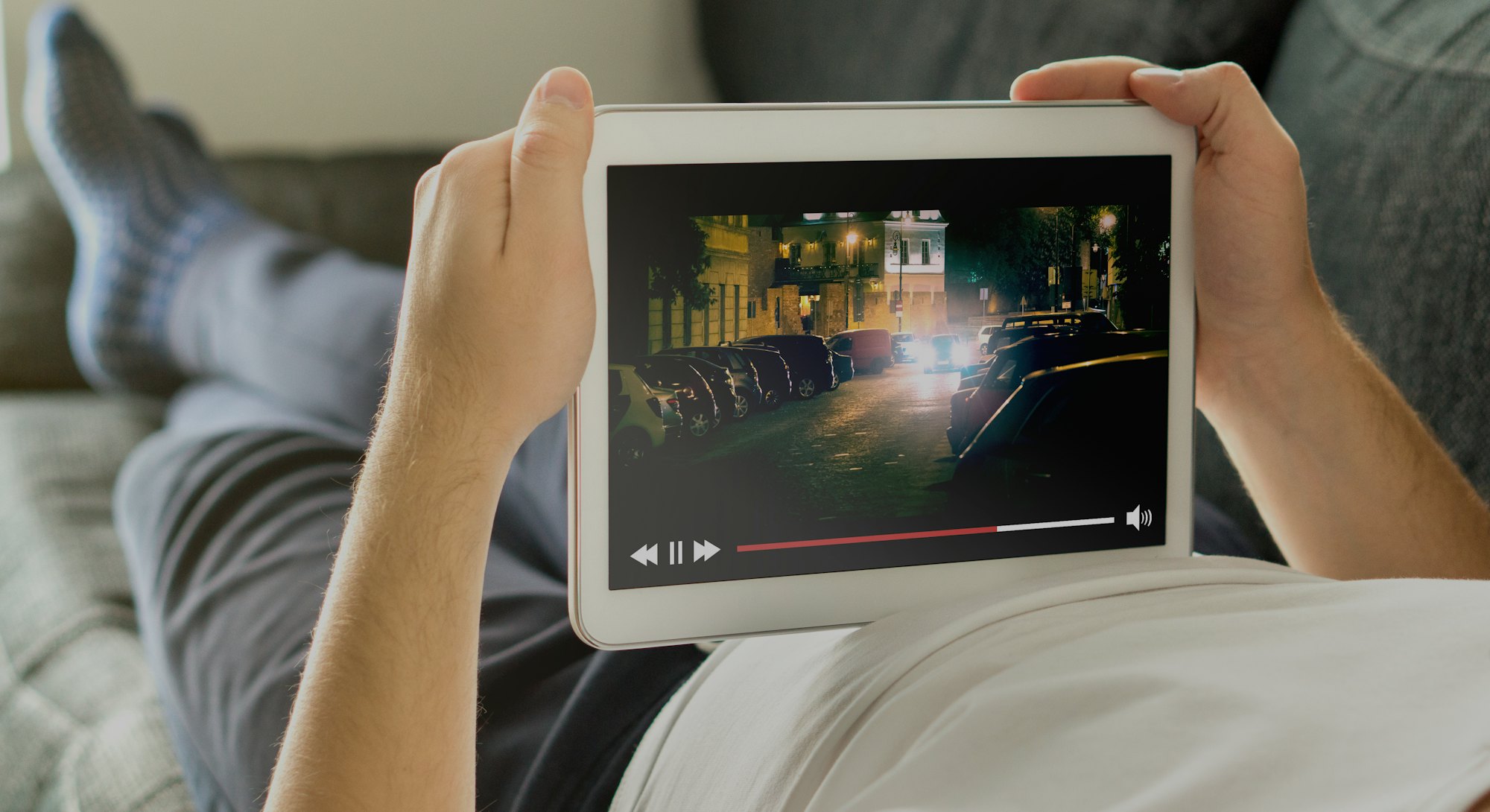 Online movie stream with mobile device. Man watching film on tablet with imaginary video player serv...