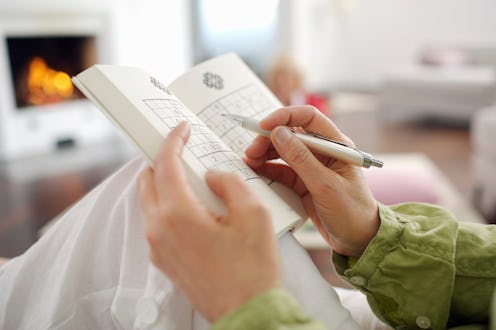 Close-up of woman playing Sudoku