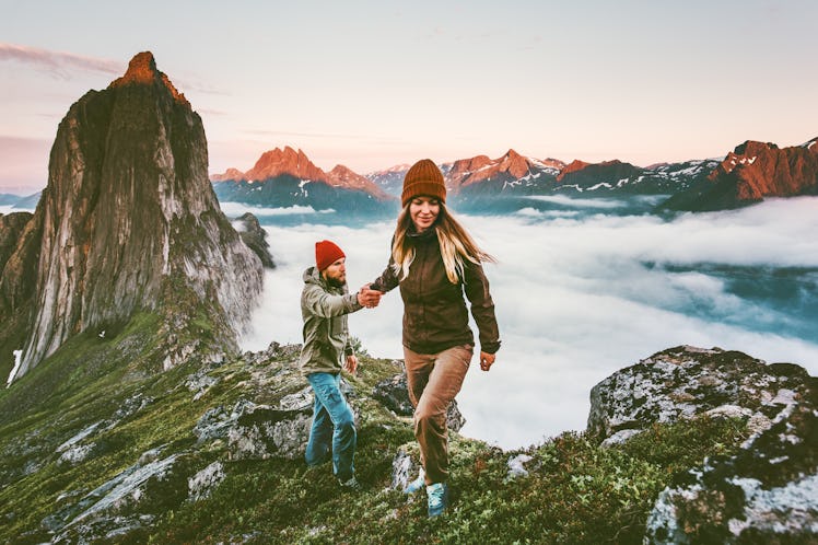 Woman hiking atop a tall mountain