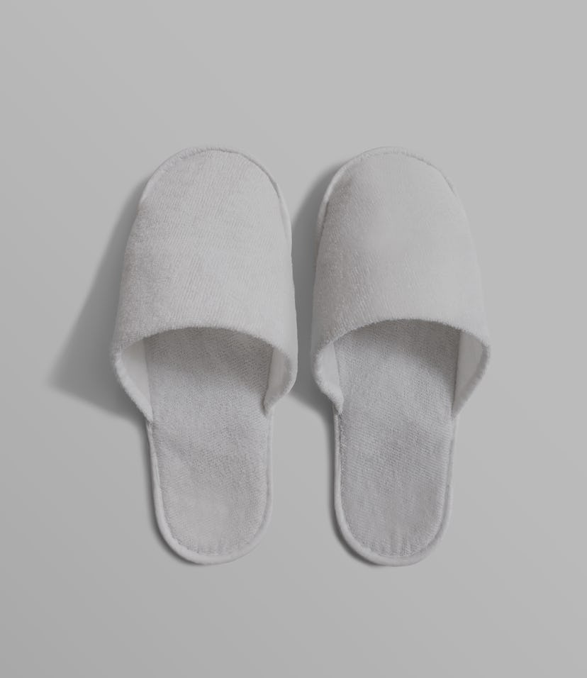Pair of blank soft white home slippers, design mockup. House plain flops mock up template top view. ...