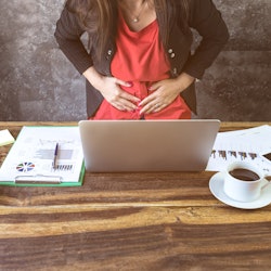 close up of  young business woman having stomach ache or Chronic gastritis, ulcer,in office, Abdomen...