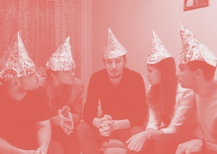 Group of people with foil on their heads discussing conspiracy theories. Friends with foil on their ...