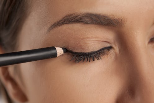 young woman applied eyeliner
