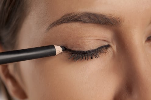 young woman applied eyeliner