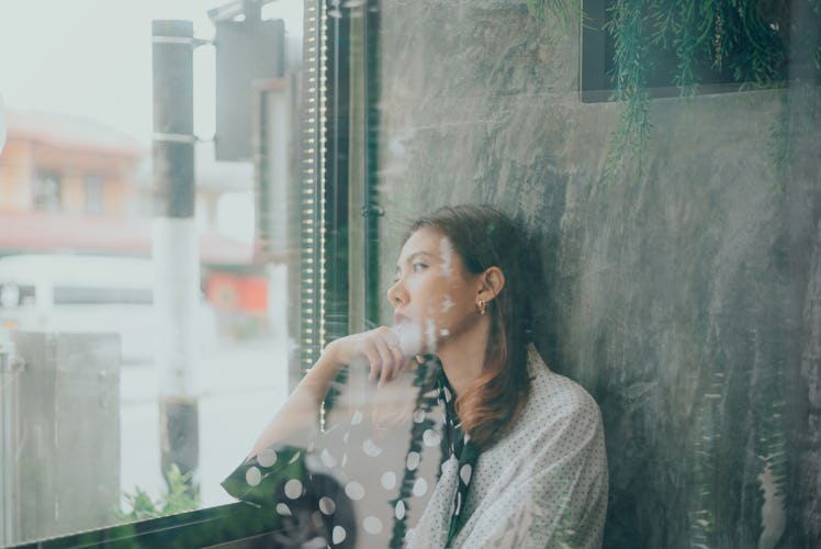 Asian woman sitting alone and depressed,Portrait of tired young woman. Depression