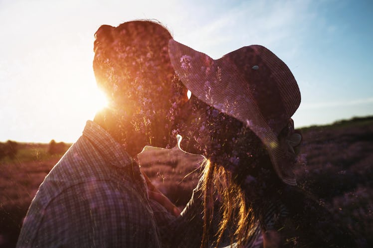 A couple kissing in the lavender field with multiple exposure at sunset.