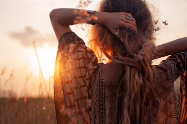 close up of beautiful young woman at sunset