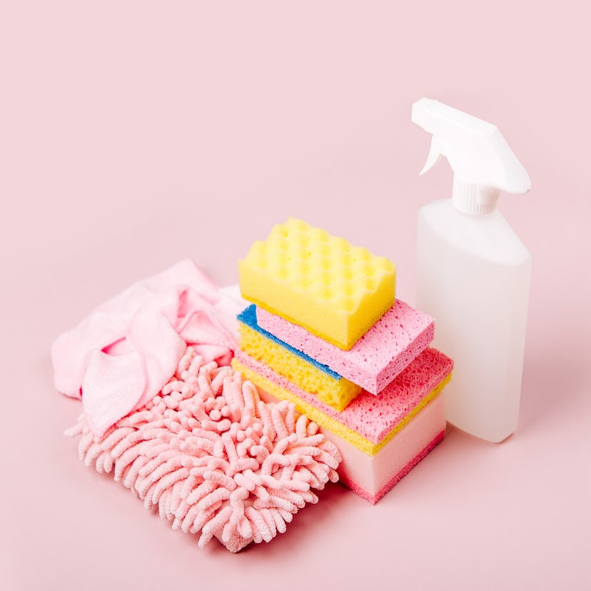 Cleaning accessories  in pink color.  Cleaning service concept. Flat lay, Top view.