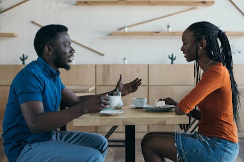 side view of african american couple having conversation during date in coffee shop