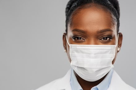 medicine, profession and healthcare concept - close up of african american female doctor or scientis...