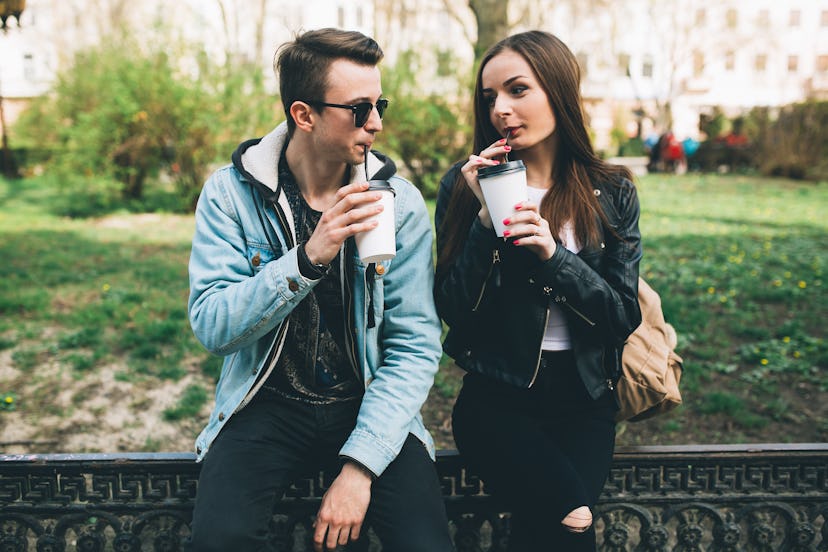 Stylish couple drinking coffee outdoors