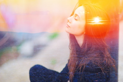 Double multiply exposure portrait of a dreamy cute woman meditating outdoors with eyes closed, combi...