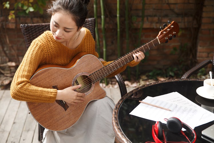 Young woman playing guitar