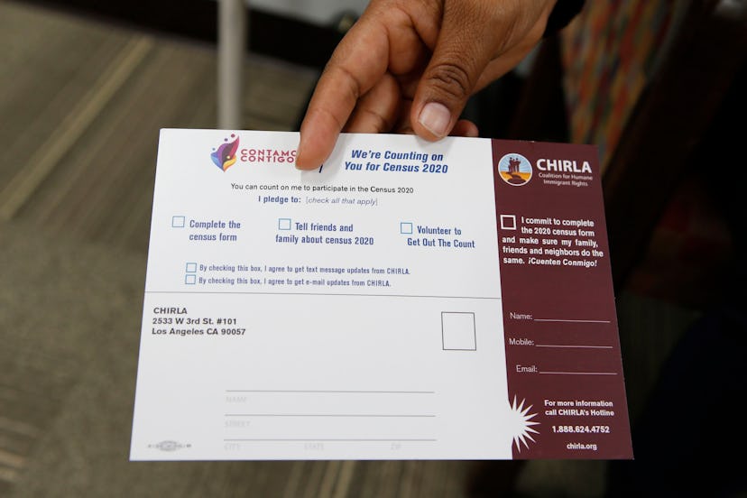 Coalition for Humane Immigrant Rights, CHIRLA volunteer Angeles Rosales holds up a CHIRLA "Contamos ...