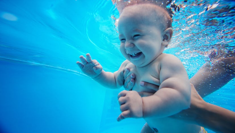 baby swimming underwater, smiling