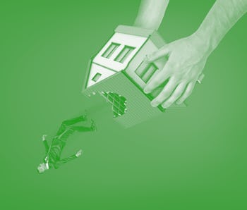 Close-up of man's hands holding house with hole in roof upside down and dropping out little business...