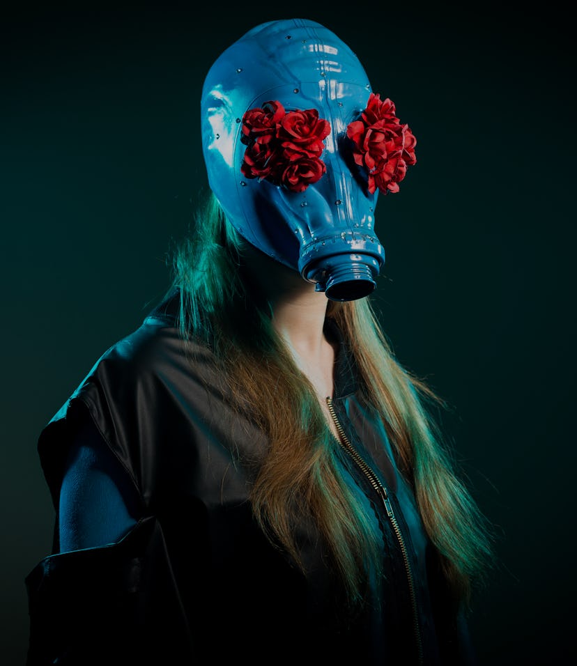 Girl in a blue gas mask on a green background