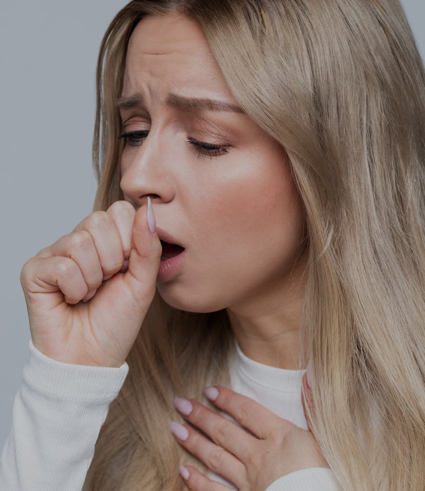 Closeup portrait of unhealthy young European blonde woman coughing a lot, suffering with cough, has ...