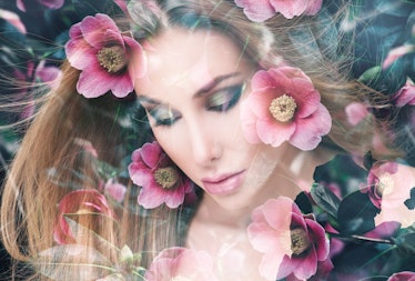 Double exposure portrait of pretty woman combined with photograph of blossoming garden flowers. Conc...
