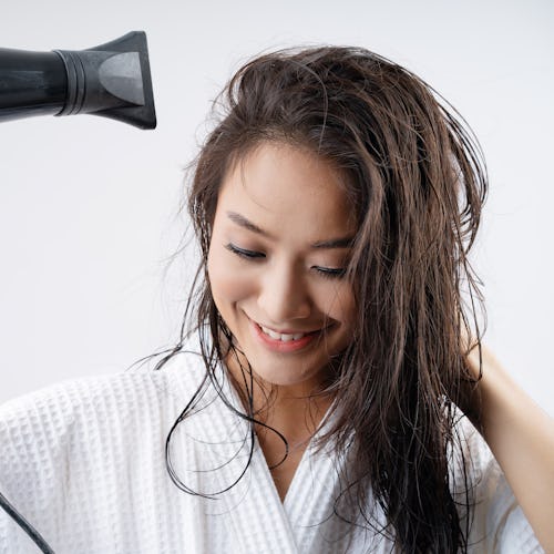 Asian woman drying your hair after showering