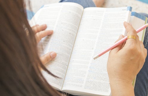 woman reading a book dictionary english for study