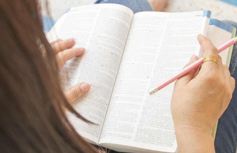 woman reading a book dictionary english for study