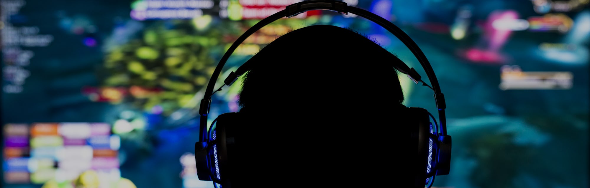 Young gamer playing video game wearing headphone.