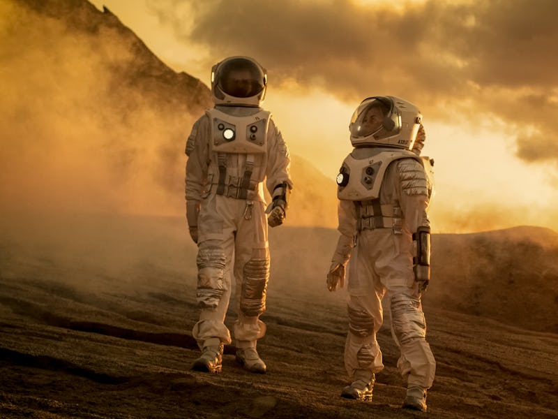 Two Astronauts in Space Suits Confidently Walking on Mars, Exploration Expedition on the Planet's Su...