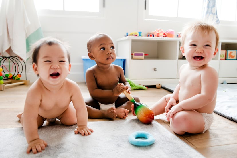 Babies playing together in a play room for an article on short unisex baby names