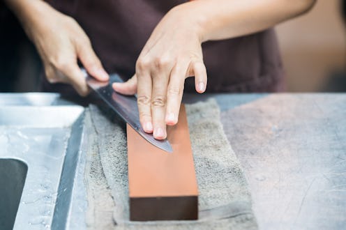 sharpening the knife with whetstone