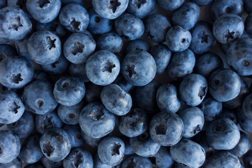 Fresh Blueberry Background. Texture blueberry berries close up. Sprinkle blueberries. Ripe blueberri...