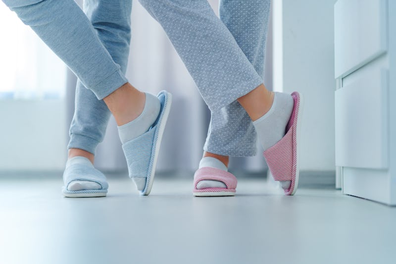 Loving married couple together in home soft comfortable slippers, family concept 