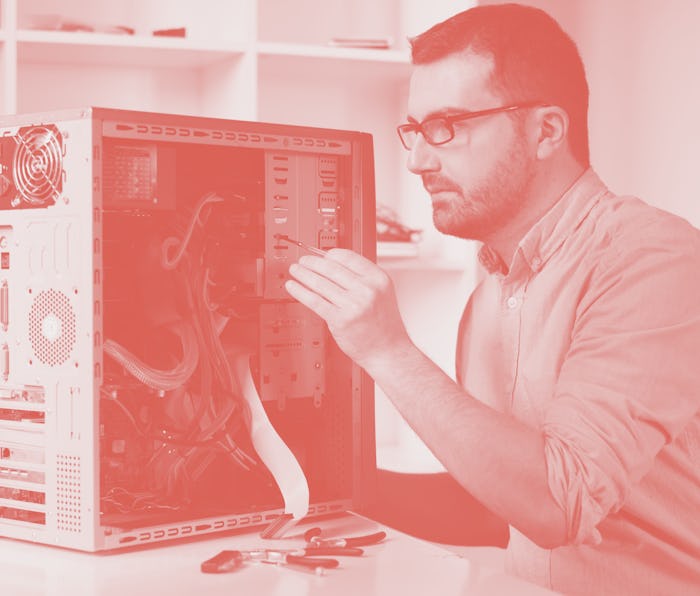 Professional man repairing and assembling a computer desktop