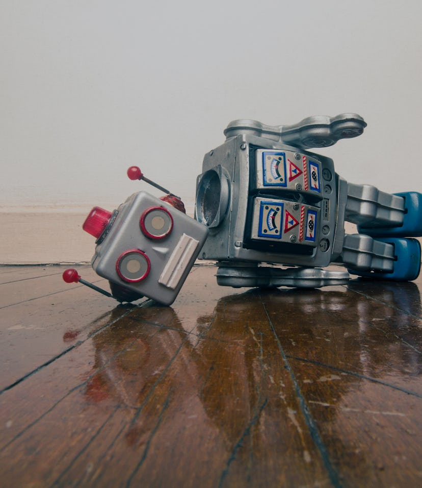 vintage bot lost his head on a old wooden floor with reflection