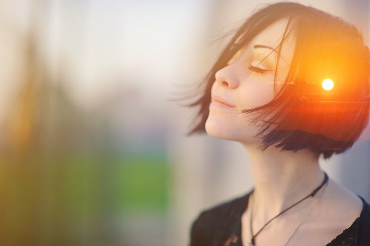 Double multiply exposure portrait of a dreamy cute woman meditating outdoors with eyes closed, combi...