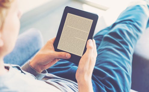 Man reading an e-book on digital tablet device