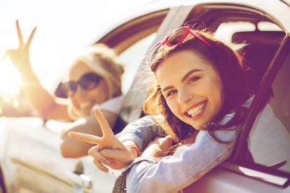 summer vacation, holidays, travel, road trip and people concept - happy teenage girls or young women...