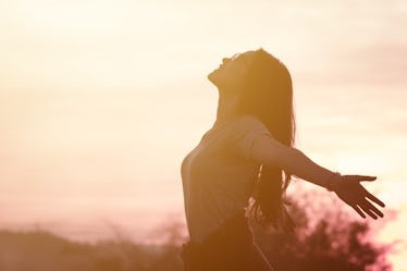 Young woman relaxing in summer sunset sky outdoor. People freedom style.