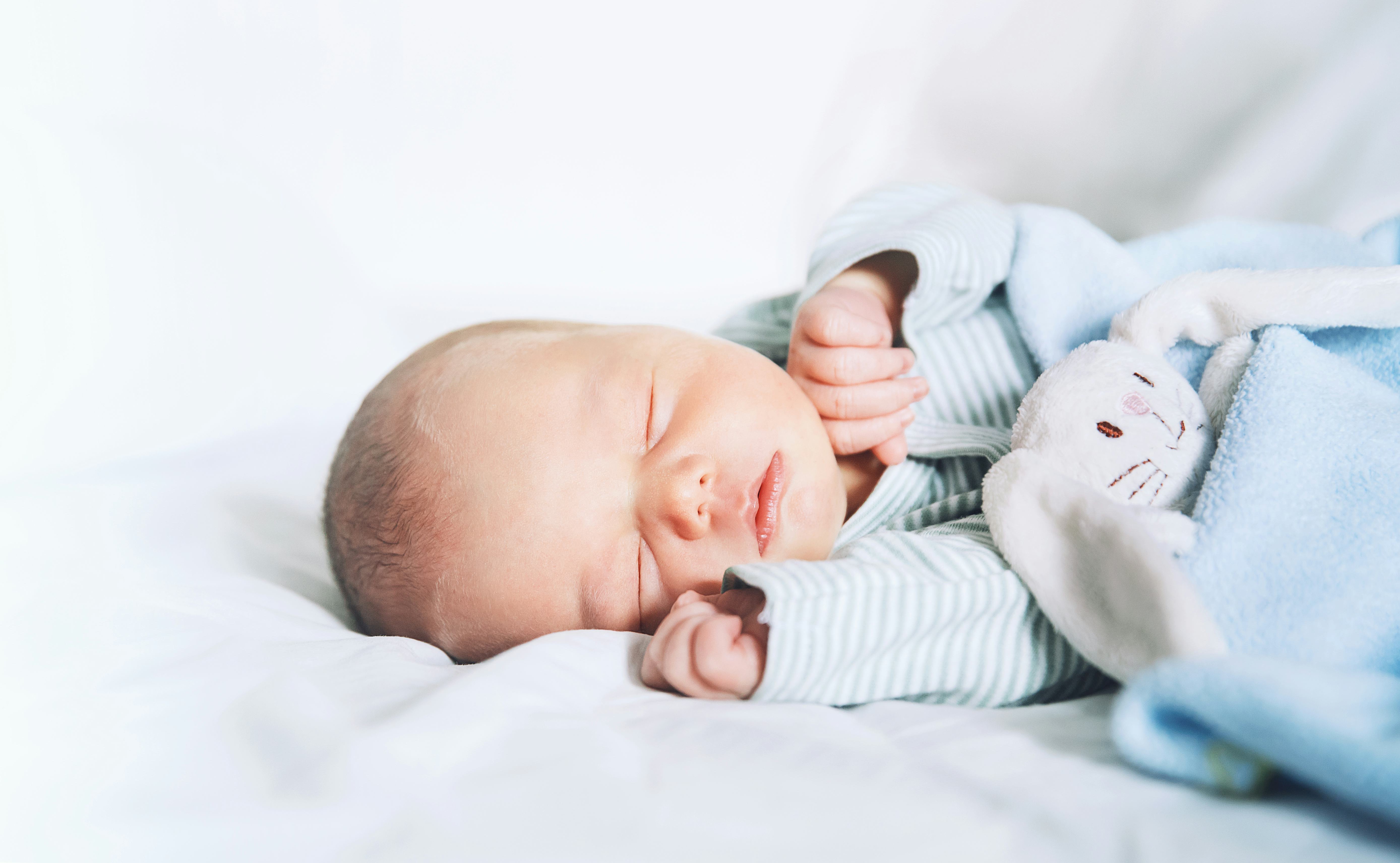 Newborn baby sleep first days of life. Cute little newborn child sleeping peacefully