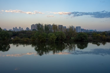 As the sun sets, the beautiful clouds and sky reflects on the calm waters of Wuhan, China on a atypi...