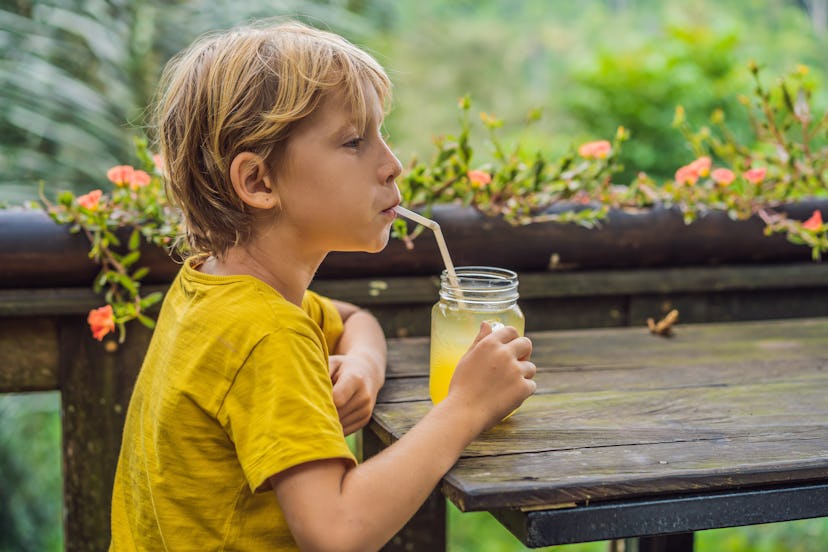 Boy drinking juice in a cafe. What to do with children. Child friendly place